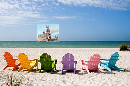 Graphic is of a sandy beach, facing the water. On the sand are 6 wooden beach chairs, each of a different color, and they are in semi-circle facing the water. On the horizon is a picture window showing a medieval style building, of rock and spires. Something to daydream about.