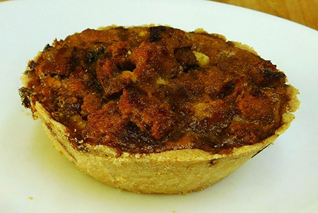 Graphic is of what looks like a small pie, with crust up to the top edge, filled with what appears to some kind of tasty appearing food